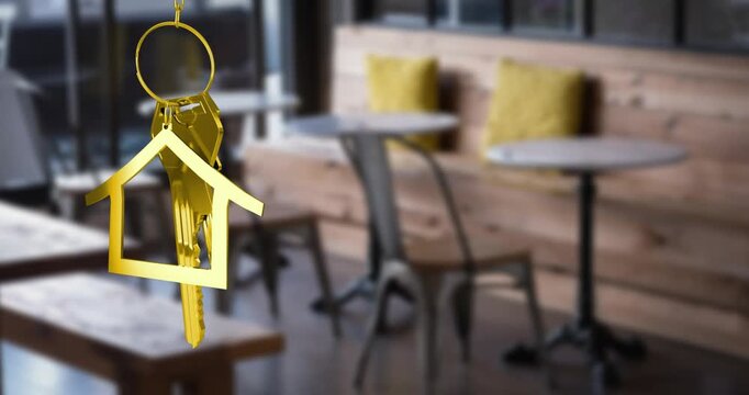 Animation of hanging golden house keys against interior of a cafe