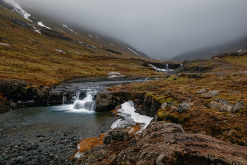 Fototapeta premium Beautiful Skutafoss waterfall flowing near Hofn. Scenic Icelandic nature with a stream falling over rocky terrain in the East Fjords.