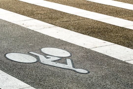 Bicycle cycling road asphalt crosswalk marking and lane transportation urban sign painted on street surface for safe commuting and mobility planning