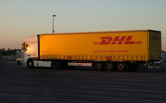 Truck parking, Poland, 22, October, 2024. Truck Dhl, Dhl freight truck on the sunset at parking. Yellow truck.