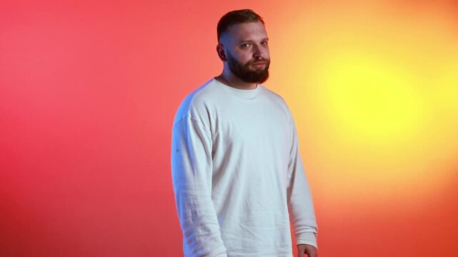 Bearded man standing confidently on colorful gradient background mid rotation. Concept of personal branding, creative agency visuals, modern identity presentation, and confident character storytelling