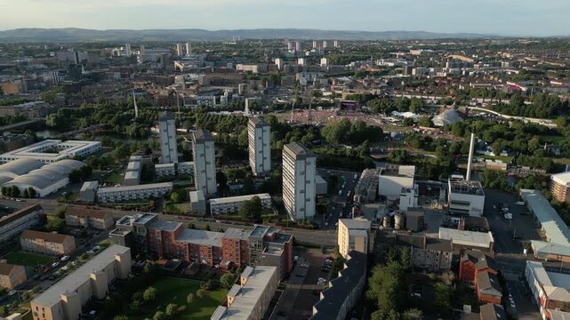Urban aerial reveal of Glasgow Green event and Gorbals skyscrapers