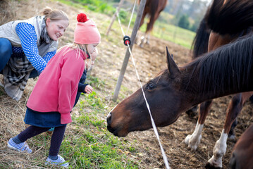 Children Approaching Horse With Adult Supervision