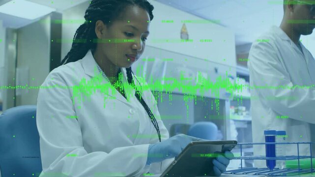 Lab scientist tapping tablet and scrolling overlays monitoring data while colleague handling tubes