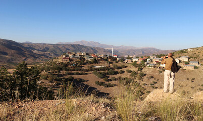 A traveler taking photos with his cell phone in the Taurus Mountains. Turkey.