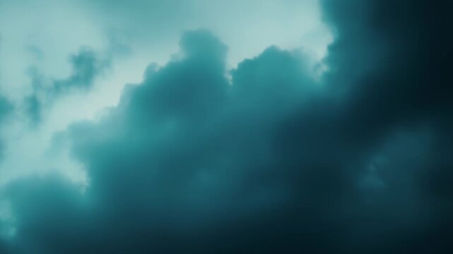 Overcast clouds forming a dramatic, abstract sky background, with swirling teal and cyan tones suggesting a pending storm, bad weather, or an ominous atmosphere