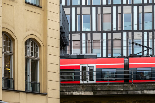 train commuter railway berlin germany beside architecture facade urban transport with windows on historic building street scene daylight