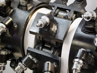 Drilling head showing parts and connections during assembly in a workshop setting with tools