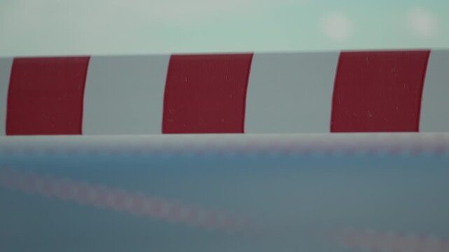 Safety barrier, striped, red and white warning tape slowly moving, abstract protective element