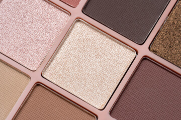 Fototapeta premium Cosmetics. Eyeshadow palette featuring a variety of colorful matte and shimmer shades. Essential cosmetic product for professional makeup artists, beauty tutorials, and fashion industry themes
