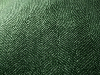 Close Up Of A Green Forest Toned Fabric Featuring A Classic Woven Herringbone Pattern