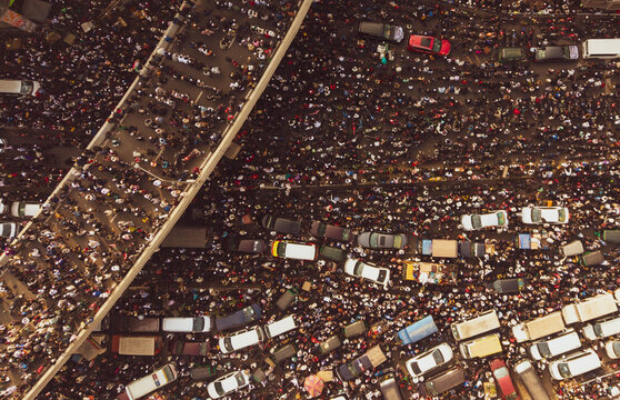 Dhaka, Bangladesh - 31 December 2025: Aerial view of a sea of people and vehicles creating a tapestry of motion beneath the city's concrete veins.