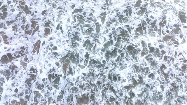 Water waves approaching shore. Ocean waves flowing forward. Sea water rushing forward. Beach surf in motion. Ocean waves crashing. Sea surf washing the beach. Ocean currents forming waves.