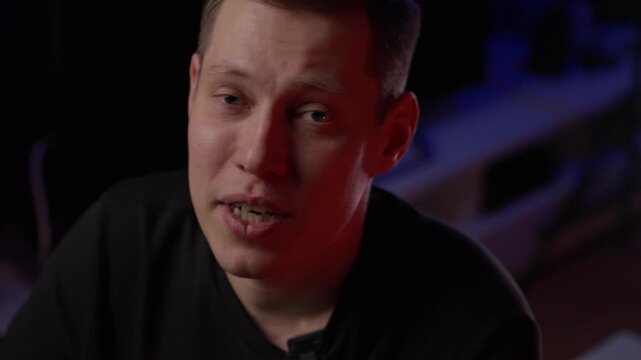 Reflective White Male Artist Speaks Softly, Intimate Narration By Male Creator With Purple Background, Quiet Male Musician Discusses Personal Experiences With Serene Studio Setting