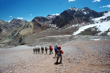 The movement of climbers in rows in extreme conditions on snowy, steep mountains
