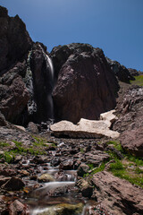 Waterfalls at the Sat Glacier Lakes. Lake landscapes in bloom in spring. Hakkari Cilo Sat Lakes. A lake view in the mountains. Hakkari Cilo Sat Glacier Lakes, mountains covered with flowers.Long expos