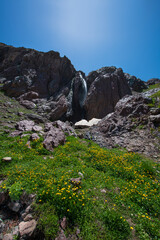 Waterfalls at the Sat Glacier Lakes. Lake landscapes in bloom in spring. Hakkari Cilo Sat Lakes. A lake view in the mountains. Hakkari Cilo Sat Glacier Lakes, mountains covered with flowers.Long expos