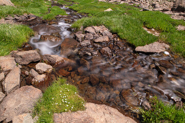 Waterfalls at the Sat Glacier Lakes. Lake landscapes in bloom in spring. Hakkari Cilo Sat Lakes. A lake view in the mountains. Hakkari Cilo Sat Glacier Lakes, mountains covered with flowers.Long expos