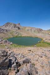 Waterfalls at the Sat Glacier Lakes. Lake landscapes in bloom in spring. Hakkari Cilo Sat Lakes. A lake view in the mountains. Hakkari Cilo Sat Glacier Lakes, mountains covered with flowers.Long expos