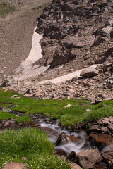 Waterfalls at the Sat Glacier Lakes. Lake landscapes in bloom in spring. Hakkari Cilo Sat Lakes. A lake view in the mountains. Hakkari Cilo Sat Glacier Lakes, mountains covered with flowers.Long expos