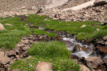Waterfalls at the Sat Glacier Lakes. Lake landscapes in bloom in spring. Hakkari Cilo Sat Lakes. A lake view in the mountains. Hakkari Cilo Sat Glacier Lakes, mountains covered with flowers.Long expos