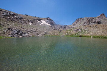 Waterfalls at the Sat Glacier Lakes. Lake landscapes in bloom in spring. Hakkari Cilo Sat Lakes. A lake view in the mountains. Hakkari Cilo Sat Glacier Lakes, mountains covered with flowers.Long expos