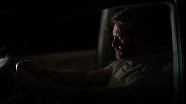 Driver in crime driving car at night. Alert driver man in car during police siren. Crime with drivers car at night. Police siren with driver in night. Man driver alert.