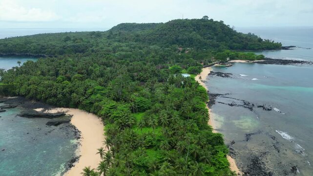Aerial backwards view over the forest at Ilheu das Rolas,It is an iconic tourist spot marking the passage of the Equator, which divides the Northern and Southern hemispheres.Sao Tom&eacute;.Africa.