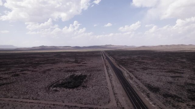 Aerial shot flying over an empty highway in the west Texas desert