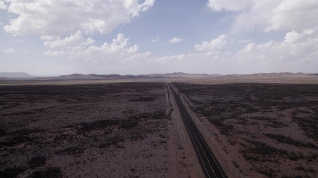 A slow moving aerial over an empty west Texas highway in a desolate desert