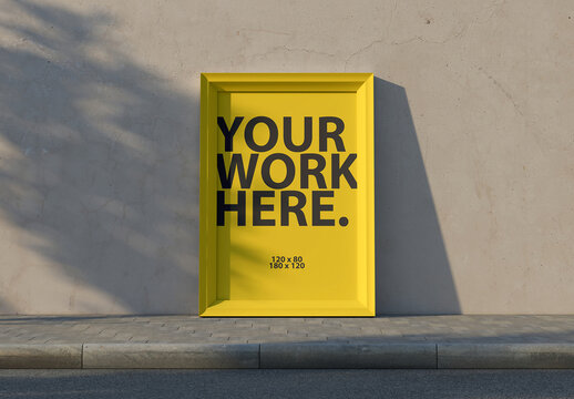 Vertical Framed poster Mockup next to concrete wall on the street