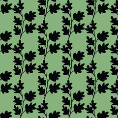  black silhouettes of leaves and branches on a mint green background.
