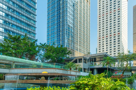 Modern urban park Chater garden with fountain surrounded by skyscrapers and greenery in Hong Kong city, China. Green city, modern business district, sustainable urban design in Asia
