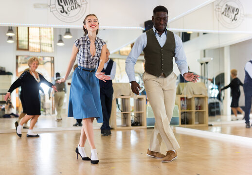 Woman and man dancing swing in studio