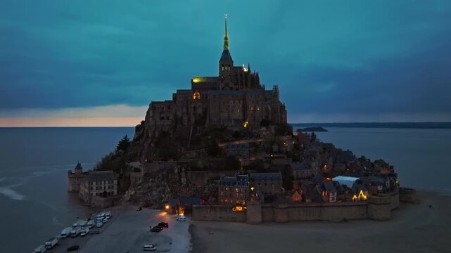 Aerial view of the famous historic Abbey Mont Saint Michel at night. Historic monastery with tidal flats. Normandy, France 