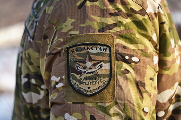 Naklejka premium Almaty, Kazakhstan - 01.20.2026 : A patch on a military uniform. The inscription in Kazakh: the armed forces of the Republic of Kazakhstan.