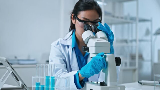 Scientist,Beautiful young woman scientist in laboratory working.female scientist doing some research.report and writing medical results,medicine documents in laboratory for healthcare,science review