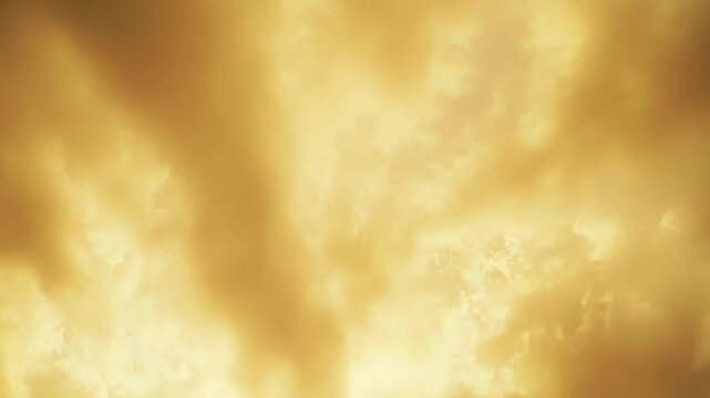 Golden hour light bathes dense clouds in warm gold and orange hues, creating a vibrant, ethereal sky perfect for themes of hope, dreams, divinity and peaceful inspiration