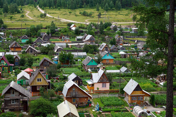 Traditional dacha village with wooden houses and green plots
