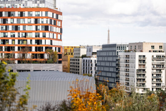 Modern residential architecture in Boulogne Billancourt Paris France in a city skyline with Eiffel view in autumn under layered clouds