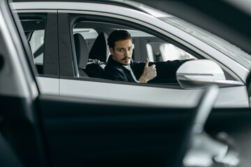 Man choosing new car in dealership