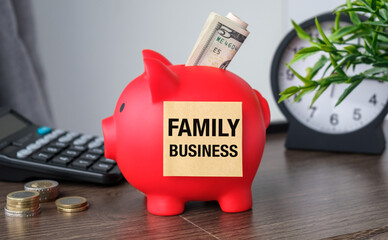 A sticker with the inscription Family Business on a piggy bank on an office desk