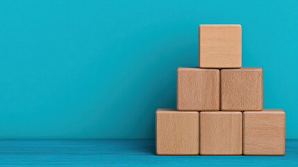 Strategic Scaling Structure Represented by Six Natural Wooden Cubes Stacked in Pyramid Arrangement against Solid Blue Wall Optimization Concept Strategic Growth Formation