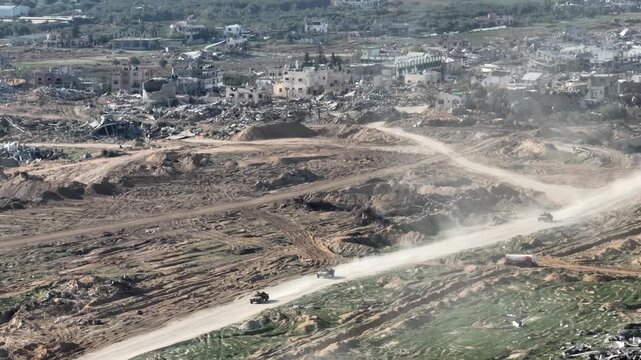 IDF Military Convoy Advancing Near Gaza Border 2023
Drone footage showing an Israeli Defense Forces military convoy moving along dirt roads near the Gaza Strip amid widespread destruction, 2023.
