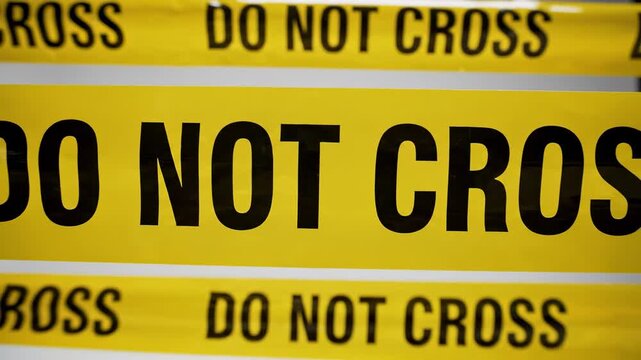 The camera executes a smooth forward zoom into multiple rows of yellow barrier tape marked with black text before pulling back. This motion creates a sense of tension and social division.