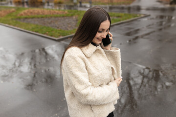 Adult girl talking on the phone in the park