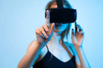 Close up of woman using virtual reality headset and pointing finger, immersive digital interaction...