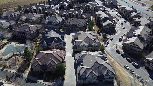 Central alleyway grid south of E Arapahoe Rd in Ponderosa East neighborhood, Arapahoe County. Terracotta and gray roofs, driveway shadows, evenly spaced highlight planned symmetry, Aurora, CO