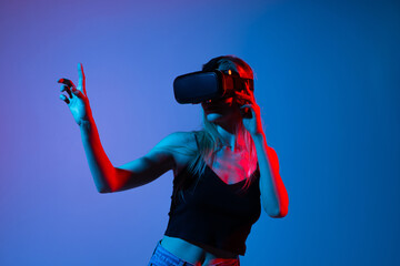 Woman Using Virtual Reality Headset Pointing at Digital Interface, Immersive Metaverse Technology...