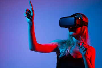 Woman Wearing VR Headset Pointing at Virtual Interface, High Tech Metaverse Experience and Future...